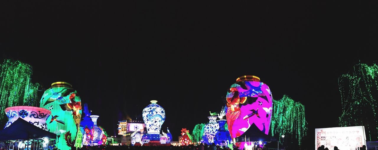 building exterior, architecture, built structure, night, copy space, clear sky, art, art and craft, illuminated, human representation, creativity, sculpture, city, statue, multi colored, religion, outdoors, low angle view, blue