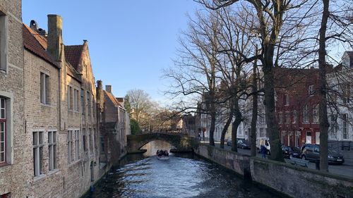 Canal amidst buildings against sky