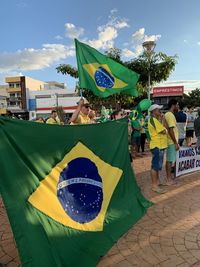 People flag on yellow flags against sky