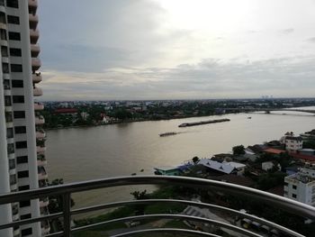 High angle view of buildings by sea against sky