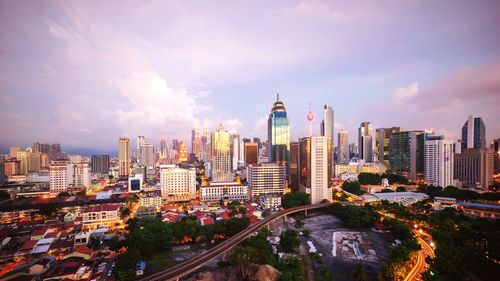 High angle view of cityscape against cloudy sky