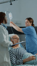 Doctors treating patient at hospital