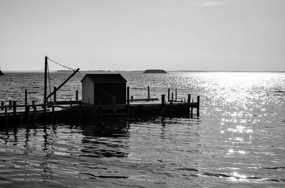 Pier on sea against clear sky