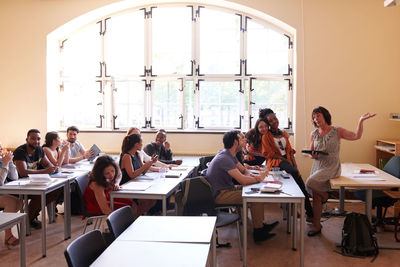 Teacher teaching to students in classroom