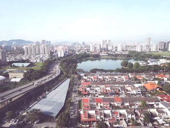 Aerial view of buildings in city against sky