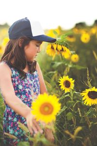 Close-up of girl on sunflower field