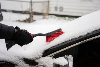 Fresh snow is cleared with a snow brush from your windshield