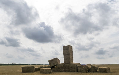 Stone structure on field against sky