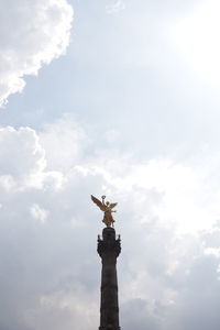 Low angle view of statue against cloudy sky