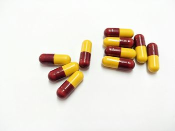 Close-up of colored pencils over white background