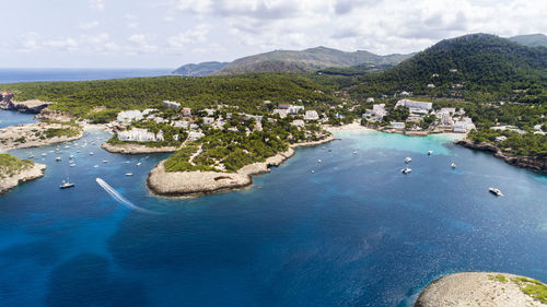 Scenic view of sea and mountains against sky