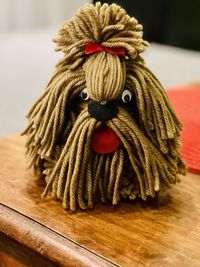 Close-up of a dog  on wooden table