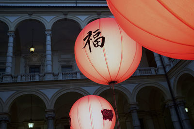 Low angle view of illuminated lanterns hanging on building