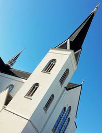 High section of building against clear blue sky