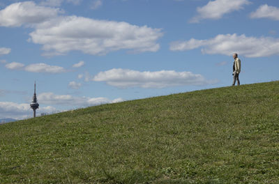 Man standing on field against sky