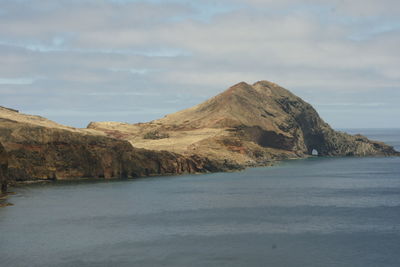 Scenic view of sea and mountains against sky