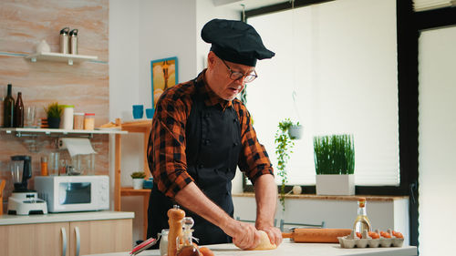 Side view of young man working at home