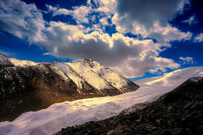 Scenic view of mountains against dramatic sky