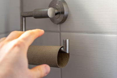 Close-up of hand holding metal door