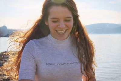 Portrait of smiling young woman at beach
