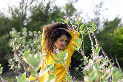 Portrait of woman with yellow flowers