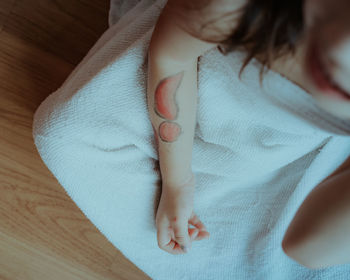 Midsection of woman lying on bed