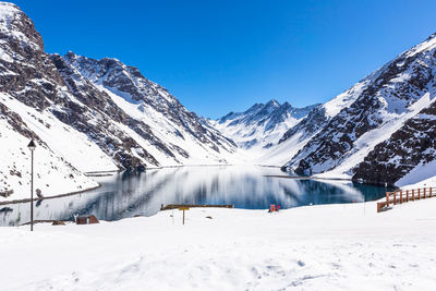 Snow covered mountains against blue sky