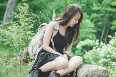 Young woman sitting on field
