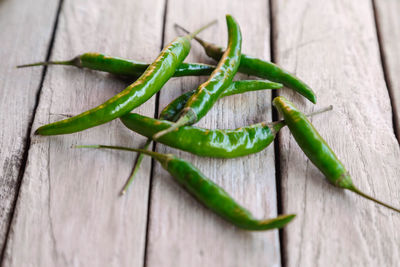 Close-up of green chili peppers on table