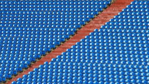 Full frame shot of blue empty chairs in stadium