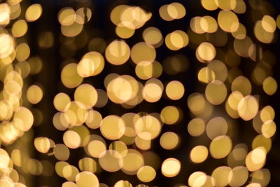 Defocused image of illuminated christmas lights at night