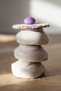 Close-up of christmas sweets stacked on wooden table