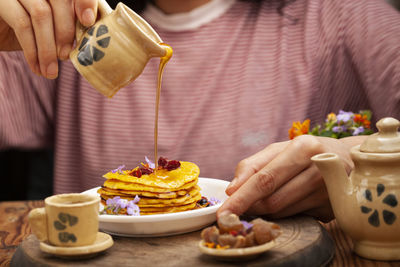 Midsection of person preparing food on table