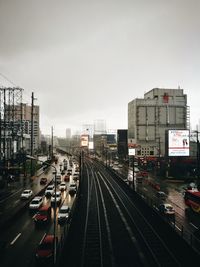 Cars moving on road in city against sky