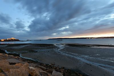 Scenic view of beach against sky during sunset