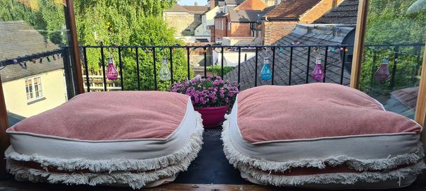 Potted plants on chair against building