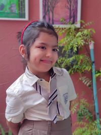 Portrait of smiling girl standing outdoors