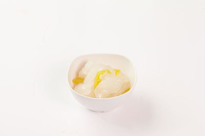 High angle view of ice cream in bowl against white background