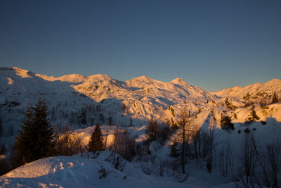 Scenic view of snow covered mountains against sky