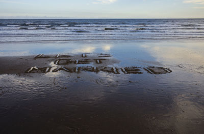 Lets get married written in the sand at filey bay