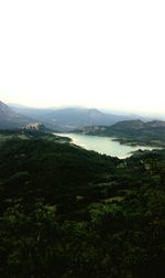 Scenic view of lake and mountains against clear sky