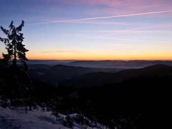 Scenic view of silhouette mountains against sky at sunset