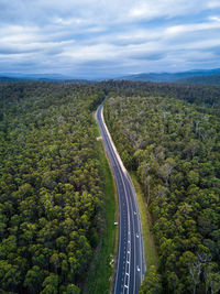 High angle view of road amidst trees against sky