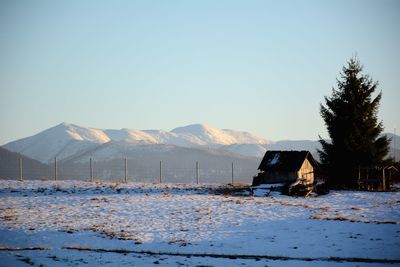 Scenic view of snowcapped mountains against clear sky