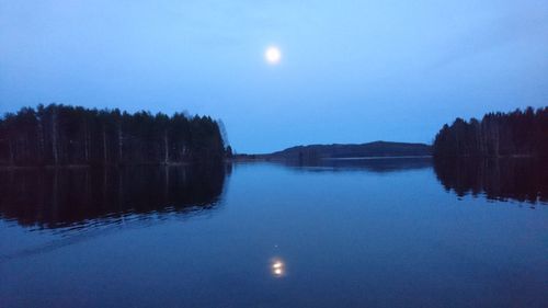 Scenic view of lake against sky at night