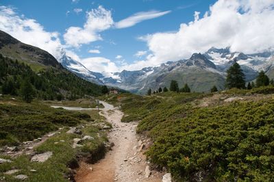 Scenic view of mountains against cloudy sky