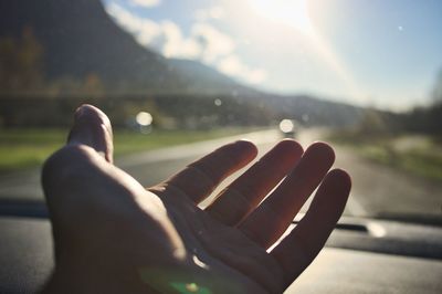 Close-up of hand against bright sun