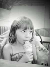 Close-up portrait of cute girl eating ice cream