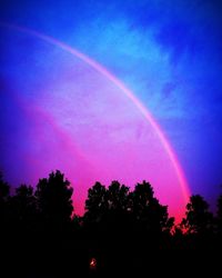 Low angle view of rainbow against sky