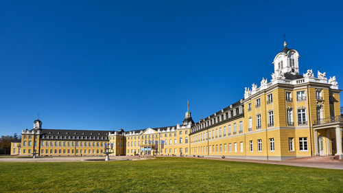 Low angle view of building against clear blue sky